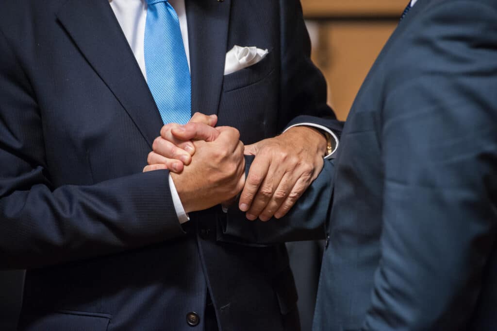 Two business men shaking hands.