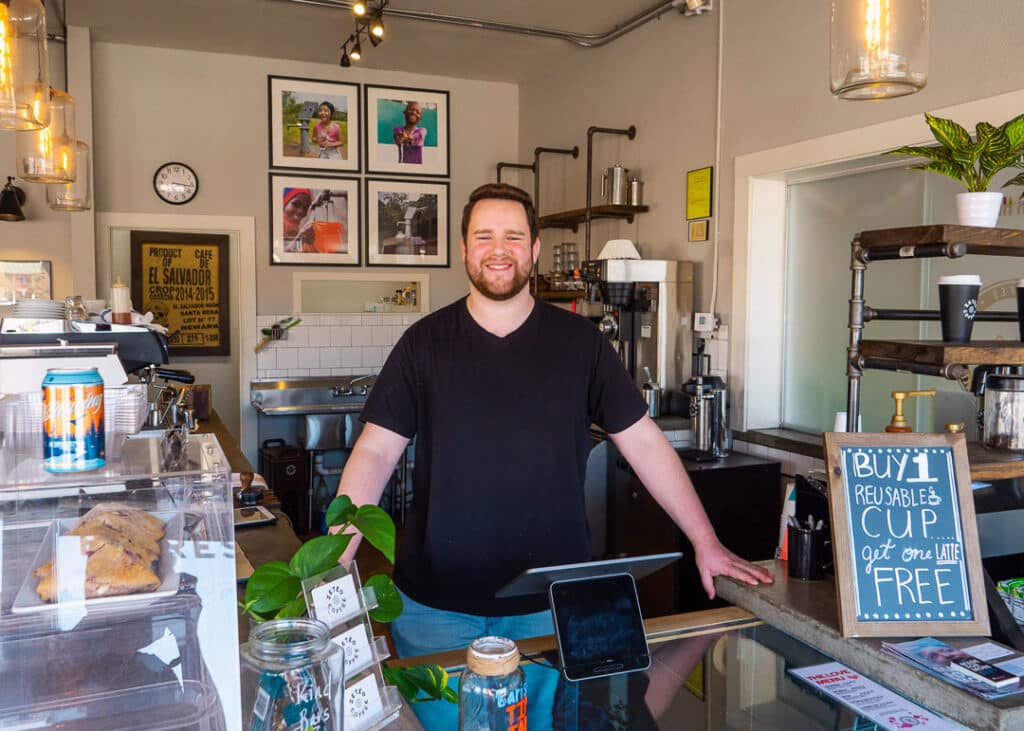 A barista behind the counter at Zeteo Coffee in downtown Conway.
