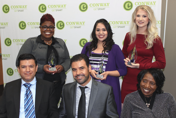 Diversity in Business Honorees holding trophies and smiling.
